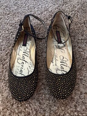 Material Girl Black Flats with Gold Stud Accents and Ankle Strap